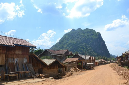 Dusty roads in Nong Khiaw with a limestone mountain backdrop