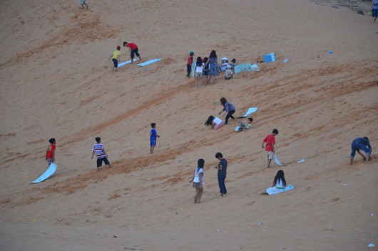Sliding down the sand dunes in Mui Ne